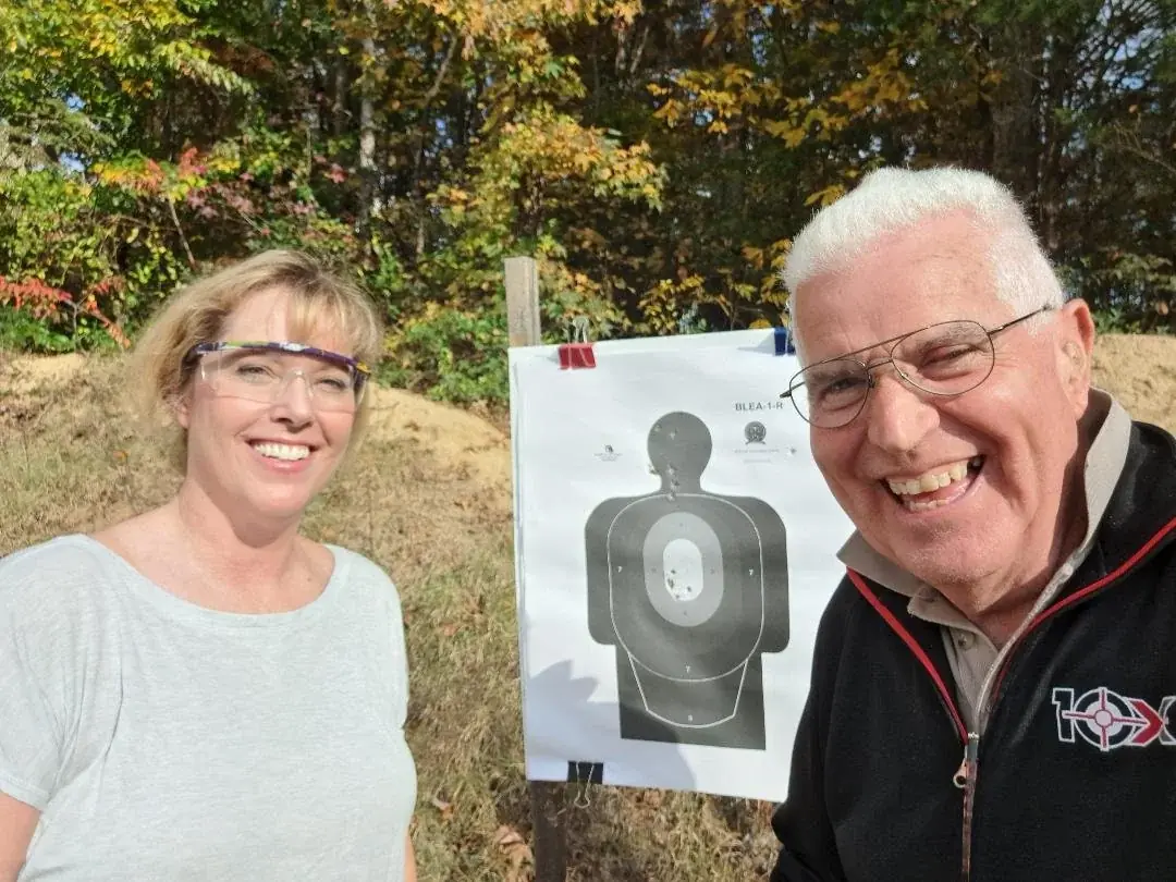 Dick Jones with a smiling shooter and her silhouette target