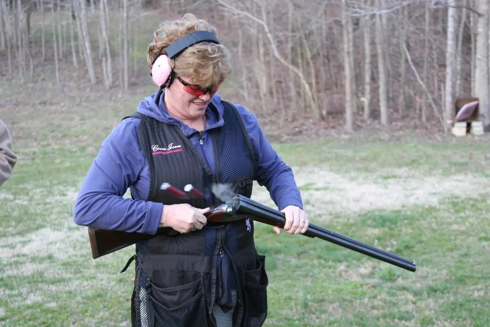 A wingshooting student preparing her shotgun at Lewis Creek Shooting School